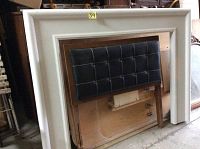 White wooden fireplace mantel with simple rectangular design and smooth finish.