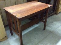 Solid oak Arts and Crafts style desk angled view showing top and side slatted supports.
