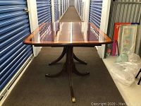 Full view of rectangular mahogany table with inlaid top and pedestal base