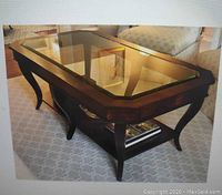 Front three-quarter view of mahogany frame coffee table with beveled glass top and lower shelf