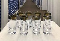 Eight Moser Splendid crystal highball glasses arranged on white cloth in storage facility