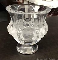 Clear and frosted glass urn with relief design on pedestal base