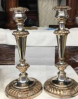 Front view of both candlesticks showing height, base design and top sockets