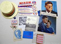 Full view of all items including hat, donkey pin, stamps, brochures and Kennedy booklet, and political bumper stickers for Nixon, Humphrey, Kennedy, and Abraham Lincoln photo card.
