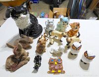 Overview of all cat figurines and animal knickknacks including large cat, small cats, owls and felt rabbits
