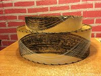 Side angle showing both levels and decorative swirl design on fiberglass surface with stitched edges.