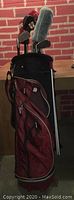 Full view of the Wilson nylon golf bag showing clubs with headcovers inside the bag