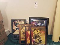 Five Toronto Maple Leafs memorabilia frames arranged leaning against wall, showing various players and gear