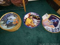 Photo showing three Star Trek collectible plates face front with colorful artwork depicting Star Trek scenes and characters.