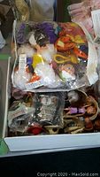 Box of sealed plush dolls including Disney characters Donald Duck, Tigger, and Minnie Mouse along with other items.