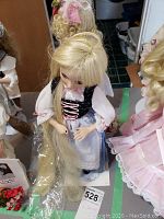 Rapunzel doll in medieval-style clothing with long blonde hair and detailed facial features.
