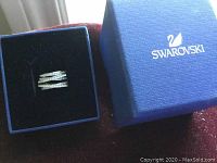 Swarovski spiral crystal ring displayed in blue Swarovski box.