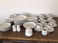 Front view of entire Summer Garden dinnerware set by Excel showing plates, cups, saucers, bowl, salt and pepper shakers, and sugar bowl.