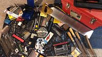 Overview of various hand tools laid out including saw, files, and hand tools