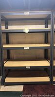 Full frontal view of the metal shelf unit showing five wooden shelves and gray metal frame.