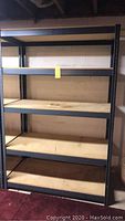 Front view of the full heavy duty metal shelf unit showing five shelves with metal framing and wooden planks.