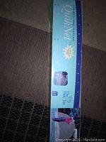 Photo of the boxed Quik Net golf practice net packaging lying on carpeted floor, showing The First Tee branding and size 8x10 feet.