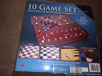 Box of 10 Game Set Distinctive Wood Cabinet showing illustrated games included and wooden game pieces.