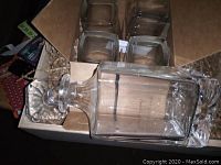 Crystal whiskey decanter and four matching whiskey glasses inside original box.