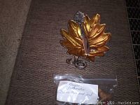 Photo showing the brass leaf-shaped dish holding a small matching knife, with the Breyer Stablemate collectibles labeled in a plastic bag beside it.