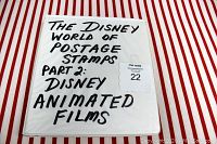 Cover of white three-ring binder with handwritten title 'The Disney World of Postage Stamps Part 2: Disney Animated Films'