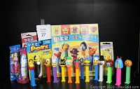 Photo showing 14 open stock PEZ candy dispensers arranged front to back with colorful character heads.