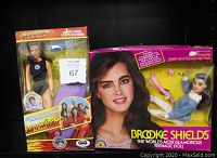 Photo showing both dolls in original boxes side by side, highlighting branding and packaging