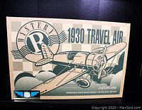 Original box packaging of the Ertl Collectibles 1930 Travel Air Mystery R die-cast metal airplane coin bank, showing the model name and vintage airplane illustration.
