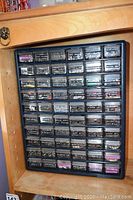 Full view of black plastic jewellery storage organizer with 56 labeled drawers.