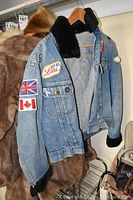 Side angle showing left arm and front patches including UK and Canadian flags.