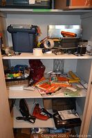 Wide view of shelves showing various toolbox, tools, tapes, painting supplies, hand tools, electric tools, and hardware items.