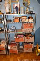 Front view of metal wire shelving unit filled with various boxes and decorative items