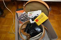 Overview of camera cases, manuals, and accessories inside a box.