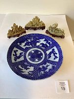 Overhead shot showing platter and three soapstone carvings