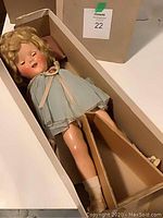 Doll lying in open original box showing full length