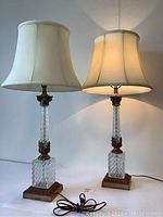 Photo of both crystal lamps together, lit, showing full structure and shades