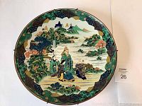 Front view of platter showing full hand-painted scene and decorative border