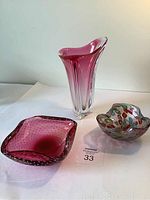 Three art glass items: tall pink vase, pink bubble square bowl, multicolored round bowl