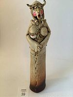 Front view of the Norwegian signed mid-century modern ceramic figurine showing the front details including helmet, glasses, and skirt design.