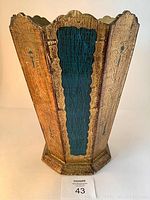 Front view of the Italian Florentine waste paper basket showing gold leaf and blue floral decorated panels with scalloped top edges.