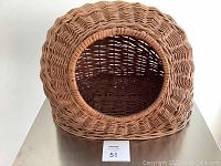 Front view showing round entrance of the wicker cat bed.