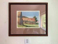 Photo showing framed watercolor painting of barn and landscape with wood frame and brown mat.