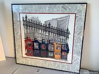 Full view of the framed print showing Toronto news boxes with wrought iron fence and large building behind.