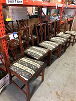 Eight chairs lined up on metal shelving