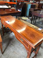 Full view of Helmand wooden sofa table showing top, drawers, and handles