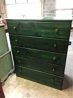 Front view of the dark green pine chest of drawers showing five drawers with round knobs
