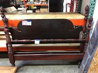 Full view of entire bed frame including headboard, footboard, and side rails showing pineapple finials and turned posts.