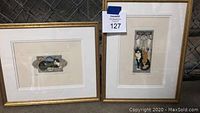 Two small framed cat pictures together showing overall size and frames