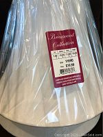 Two new 7-inch Brentwood Collection lamp shades wrapped in plastic showing label and price $16.99 each.