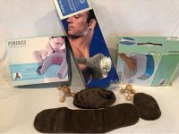 Photo showing Brookstone handheld massager, HoMedics neck and shoulder massager with heat, spa wax bath device, and accessories laid out on white surface.